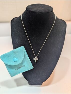 Tiffany & Co. Paloma Picasso sterling silver Tenderness heart cross necklace.